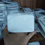 Hand holding stack of white eggshell stickers from sample pack